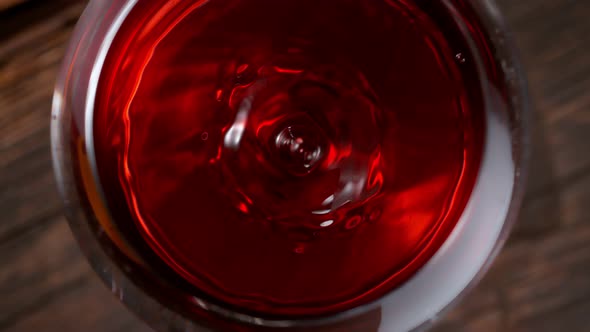 Super Slow Motion Macro Shot of Dripping Droplet Into Filled Glass of Red Wine at 1000Fps