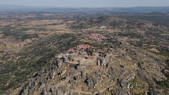 Epic megalithic fortress ruins, Monsanto in Portugal. Aerial forward tilt down