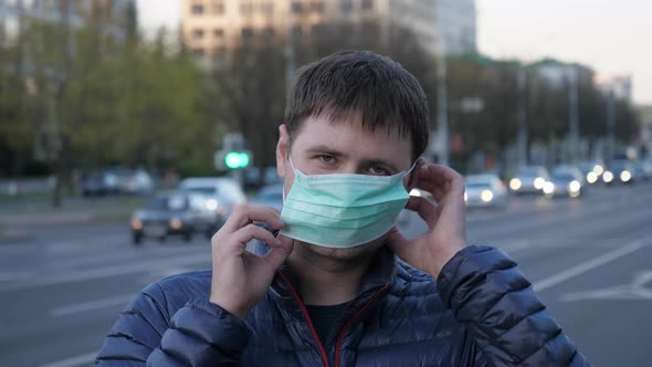 Portrait Young Man Wearing Protective Medical Mask On His Face On City Streets