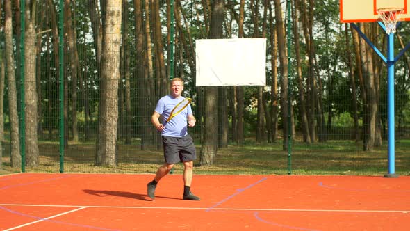 Male Tennis Player Hitting Backhand in Tennis Game