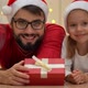Father and Girl with Gifts Look at Camera Smile and Laugh Next to Christmas Tree - VideoHive Item for Sale