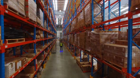 Warehouse worker on hoverboard at warehouse