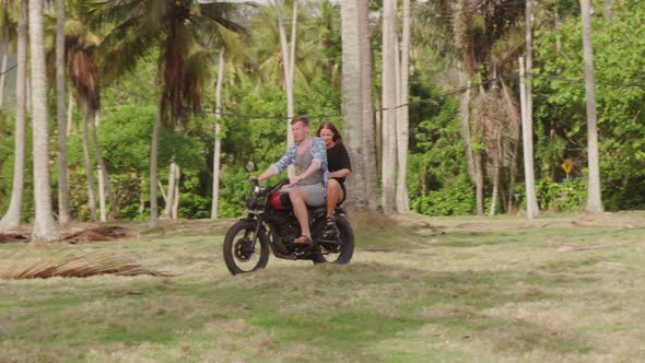 Carefree Couple Riding Motorcycle in Bali