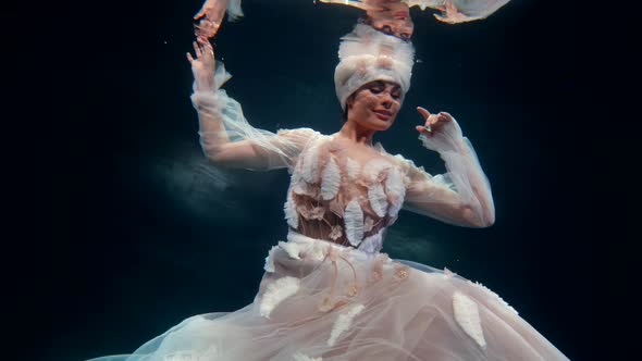 Fairytale Woman is Floating in Magical Depth of Sea Mysterious Female Figure in Gown in Dark Water