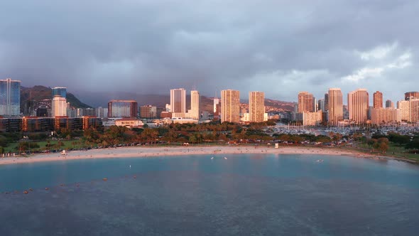 Push-in aerial shot of Ala Moana Beach in Honolulu on the island of O'ahu, Hawaii at sunset. 4K