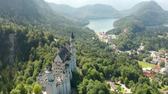 Aerial Footage of Neuschwanstein Castle Next To Lake Alpsee, Bavaria, Germany.