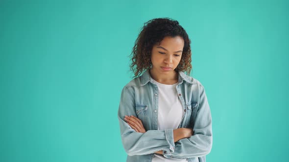 Portrait of Unhappy African American Teenager Standing with Arms Crossed