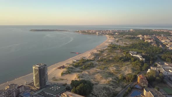 Aerial view of Sunny Beach city that is located on Black Sea shore. Top view of sand beaches with 