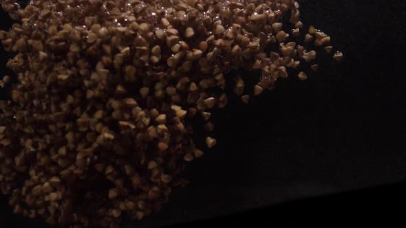 Buckwheat Falls Into Water. Underwater Shooting of Buckwheat. Slow Motion. Food Video