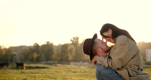 Romantic Couple Hugging in the Field at Sunset