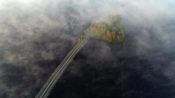 Flying Over Highway with Cars and Foggy Lake in Finland, Near Rovaniemi