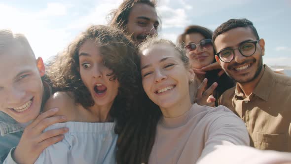 POV Portrait of Happy Young People Friends Taking Selfie Having Fun and Looking at Camera Outdoors