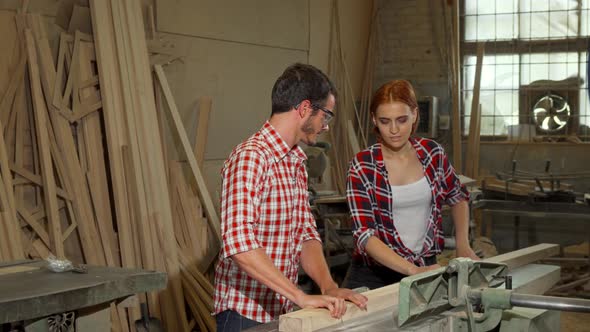 Two Young Carpenters Doing Woodwork at Furniture Manufacturing