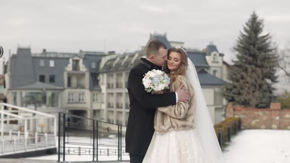 Newlyweds. Caucasian Groom Kisses Bride. Wedding Couple. Happy Family. Winter