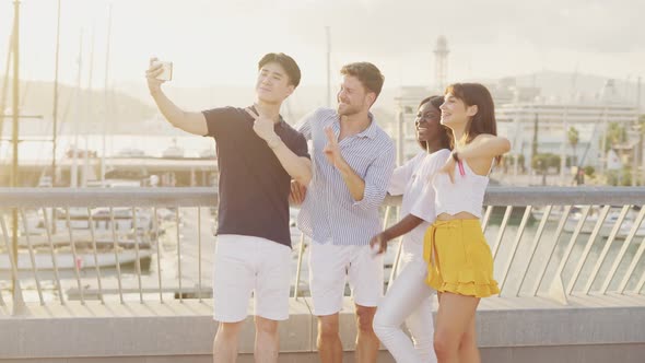 Laughing Friends Taking Selfie on Seashore