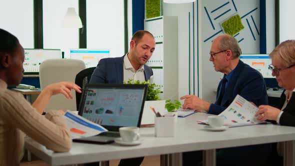 Businessman in Suit Talking to Diverse Business People Partners