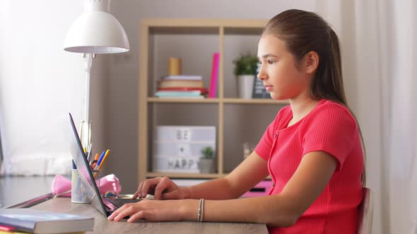 Student Girl with Laptop Computer Learning at Home