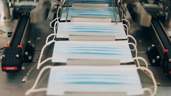 Medical Masks Moving Along a Conveyor at a Face Mask Production Factory