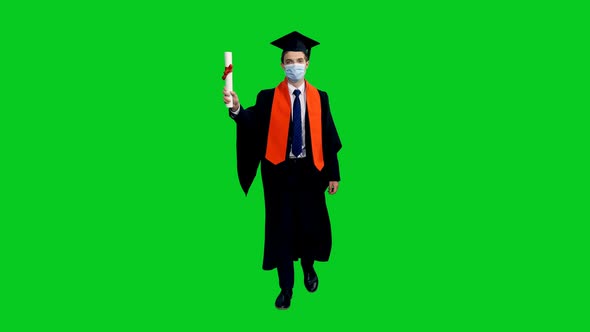 Graduating Student In Protective Mask Walking And Showing Diploma