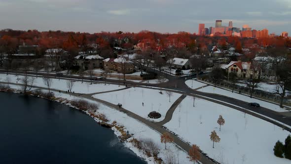 Minneapolis downtown in the background lighted up by the last moments of sun light, aerial view