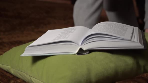 Beautiful Girl Reads a Book Comfortably While Lying in Bed