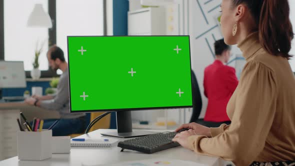 Company Worker Using Isolated Green Screen on Monitor