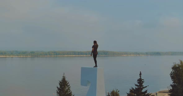 Man Stands on a Very High Pedestal a Beautiful Panoramic View of the River