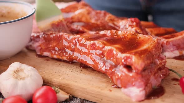 Ribs Get Glazed with Brush with Sweet Barbeque Sauce in Slow Motion Closeup