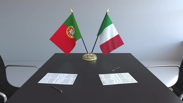 Flags of Portugal and Italy on the Table alt
