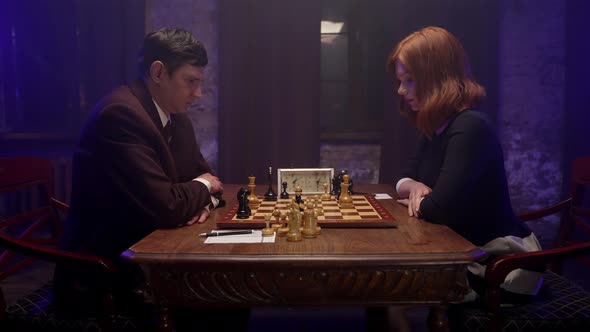 Man And Woman Play Chess