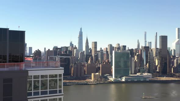 A high angle view on a sunny day with blue skies. The drone camera high up over a new luxury apartme