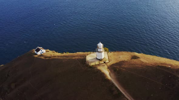 Lighthouse and House of Its Keeper on Cape Near Sea