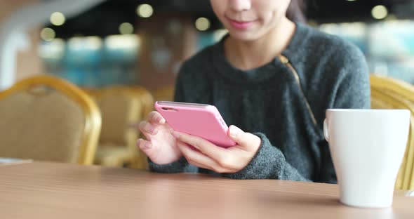 Woman use of smart phone in coffee shop