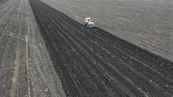 Aerial. Tractor Plows a Field