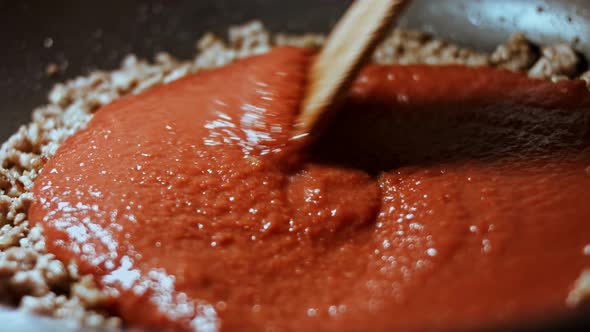 In a Frying Pan with Vegetable Oil Fry Minced Meat Onions and Carrots with Tomato Paste