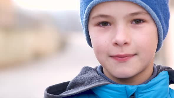 Portrait of Happy Child Boy in Warm Clothes in Autumn Outdoors