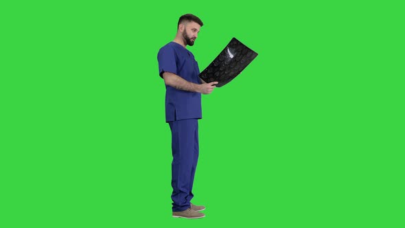 Shocked Doctor Looking at Brain Mri Result on a Green Screen, Chroma Key