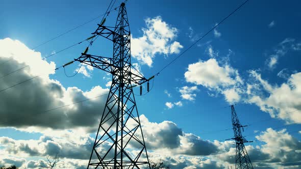 Power Lines And Blue Sky Time Lapse. High Voltage Electricity Transmission Pylon. Voltage Electric.