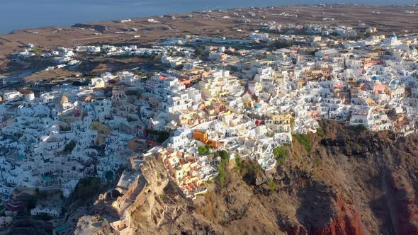 Aerial shot of famous Oia village in Santorini at sunrise in Greece