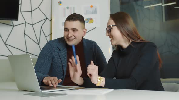 Man and Woman Working Together in the Office