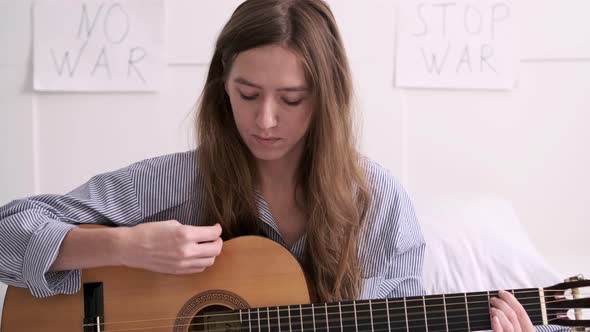 Woman Plays Guitar