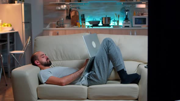 Exhausted Man Falling Asleep While Working on Internet Communication Project