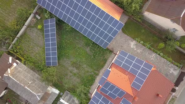 Aerial view of a private house with solar panels on roof. Photo voltaic system for renewable energy