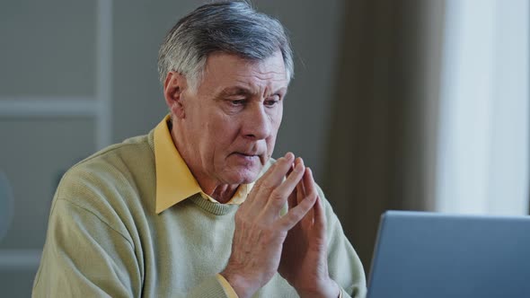 Old Caucasian Man Elderly Pensioner Typing on Laptop Thinks Waiting for Answer to Message Notice