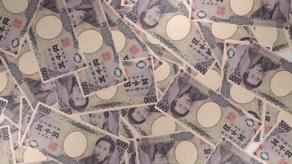 5000 Japanese yen bills background. Many banknotes.