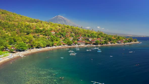 Low Angle Drone Moving Over the Boats on the Sea at Jemeluk Bay at Background Agung Volcano, Amed