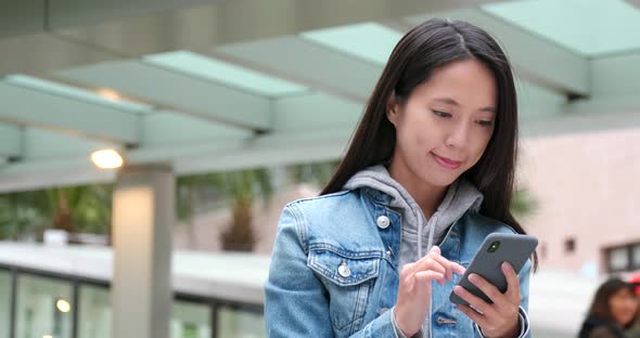 Young woman work on cellphone at outdoor