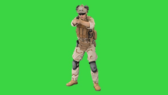 American Soldier with Pistol Aiming and Shooting on a Green Screen, Chroma Key.