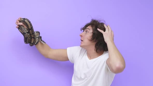 Closeup of a Snake Crawling on a Man's Arm