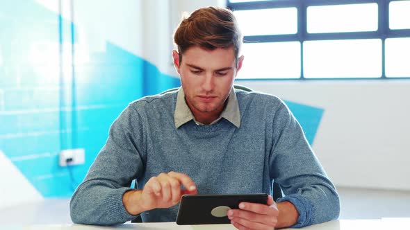 Man using digital tablet and looking at documents